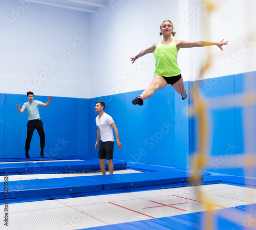 Female gymnast jumping on trampoline © JackF