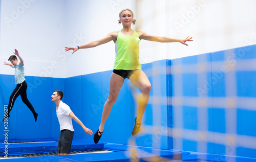 Woman training in trampoline center