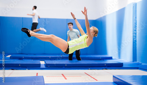 Woman jumping in trampoline center
