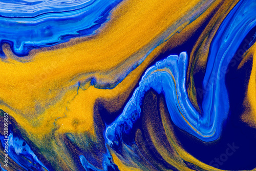 Fluid art texture. Abstract backdrop with swirling paint effect. Liquid acrylic picture with chaotic mixed paints. Can be used for posters or wallpapers. Blue, golden and white overflowing colors