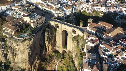 Ronda Spain in the province of Málaga with Puente Nuevo arch bridge joining the villages, Aerial tilt down reveal shot