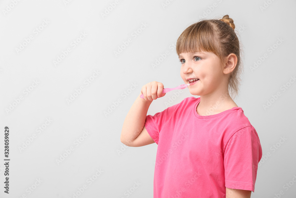 Little girl with tooth brush on light background Little girl with tooth brush on light background