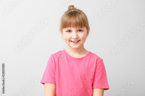 Smiling little girl on ligh...