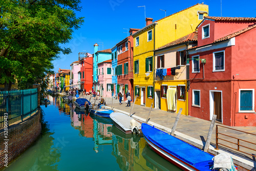 Street with colorful buildings and canal in Burano island, Venice, Italy. Architecture and landmarks of Venice, Venice postcard © Ekaterina Belova