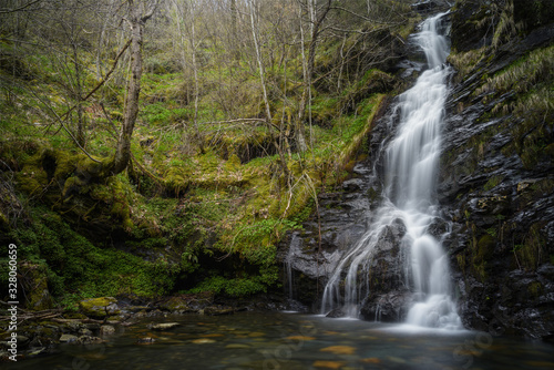 Fototapeta Naklejka Na Ścianę i Meble -  Fairy Tale Ambient on a Waterfall among Forests