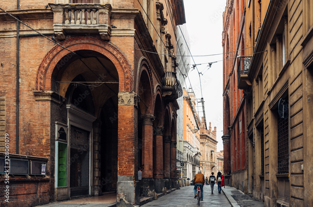 Old narrow street with arcade in Bologna, Emilia Romagna, Italy. Cityscape of Bologna.