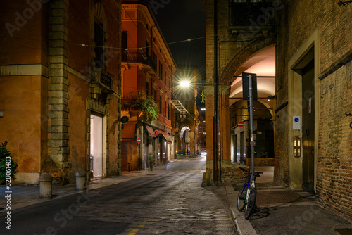 Old narrow street in Bologna at night  Emilia Romagna  Italy. Architecture and landmark of Bologna. Cozy cityscape of Bologna.
