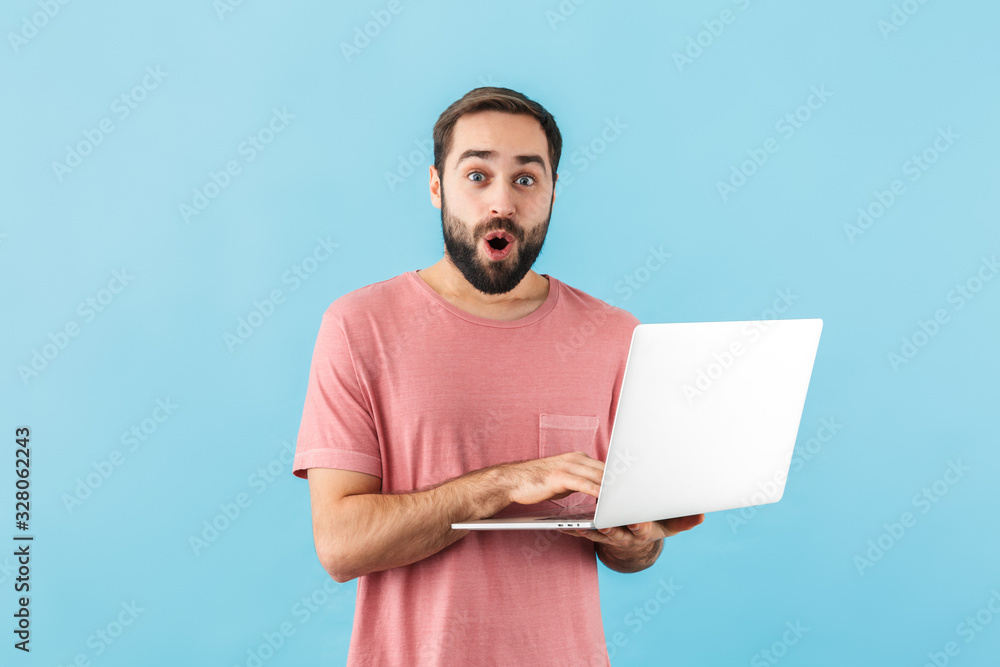 Portrait of a young cheerful bearded man wearing t-shirt Portrait of a young cheerful bearded man wearing t-shirt