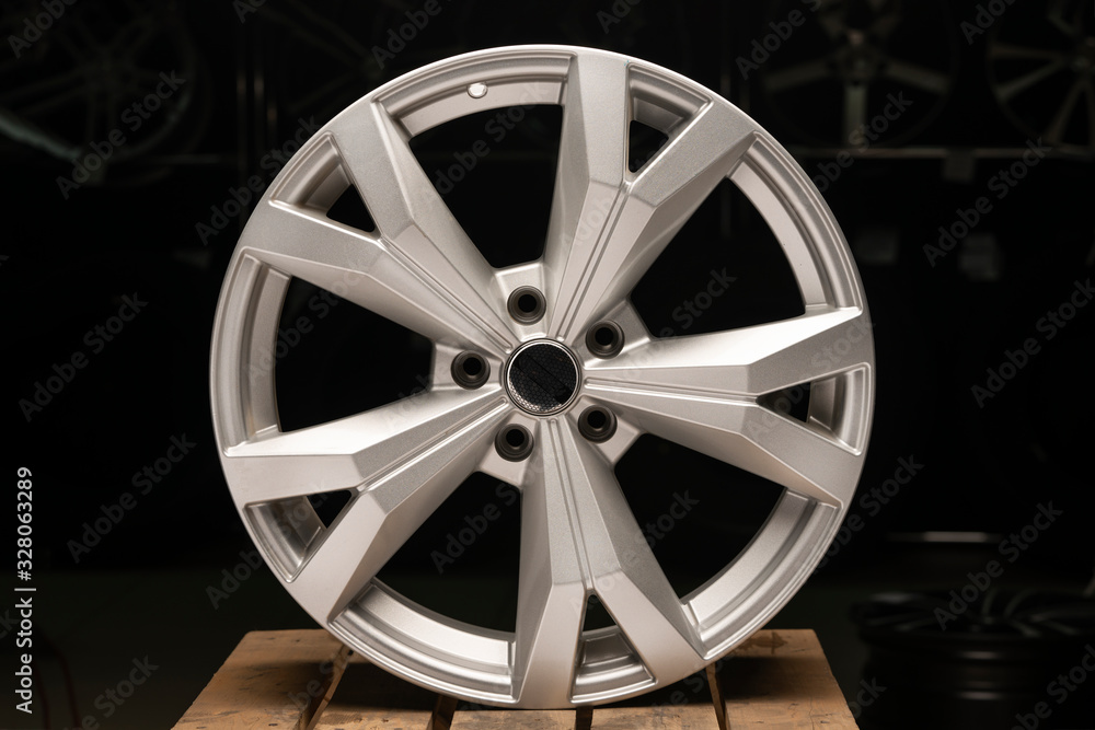 silvery new cast aluminum wheels on a black background close up