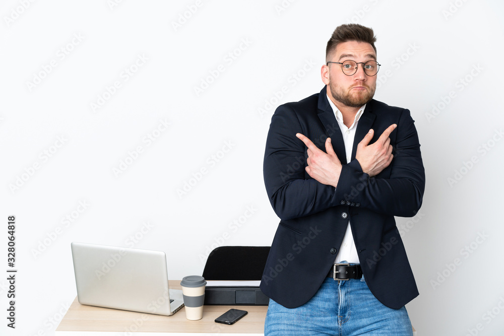 Russian man in a office isolated on white background pointing to the laterals having doubts Russian man in a office isolated on white background pointing to the laterals having doubts