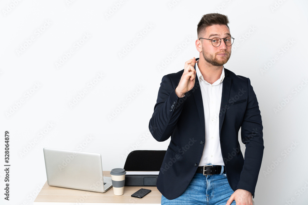 Russian man in a office isolated on white background with fingers crossing and wishing the best Russian man in a office isolated on white background with fingers crossing and wishing the best