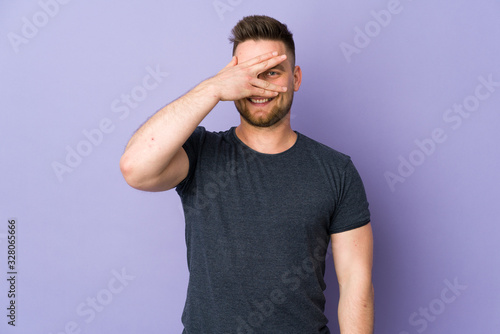 Russian handsome man over isolated background covering eyes by hands and smiling