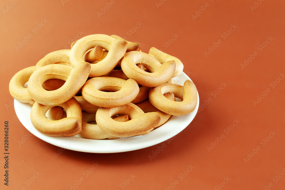 Sweet round crisps lined with flour and sugar on a black background with space for text