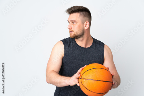 Russian handsome man isolated on white background playing basketball © luismolinero