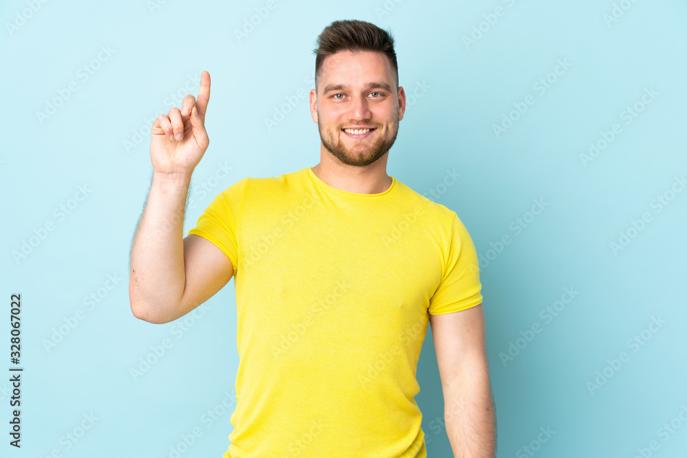 Russian handsome man isolated on blue background pointing up a great idea Russian handsome man isolated on blue background pointing up a great idea