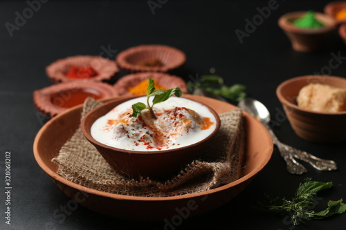 Dahi vada (Deep fried balls served with curd), thandai are well known indian Holi snack. (Holi Concept)