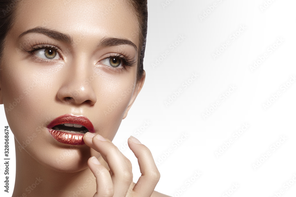 Beautiful woman with clean skin, bright glitter lips makeup. Perfect eyebrows shapes. Close-up face with shiny make-up Beautiful woman with clean skin, bright glitter lips makeup. Perfect eyebrows shapes. Close-up face with shiny make-up