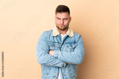 Russian handsome man over isolated background with unhappy expression © luismolinero