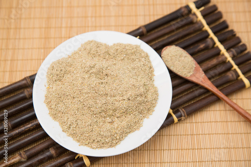 A pile of rice bran in a bamboo basket photo