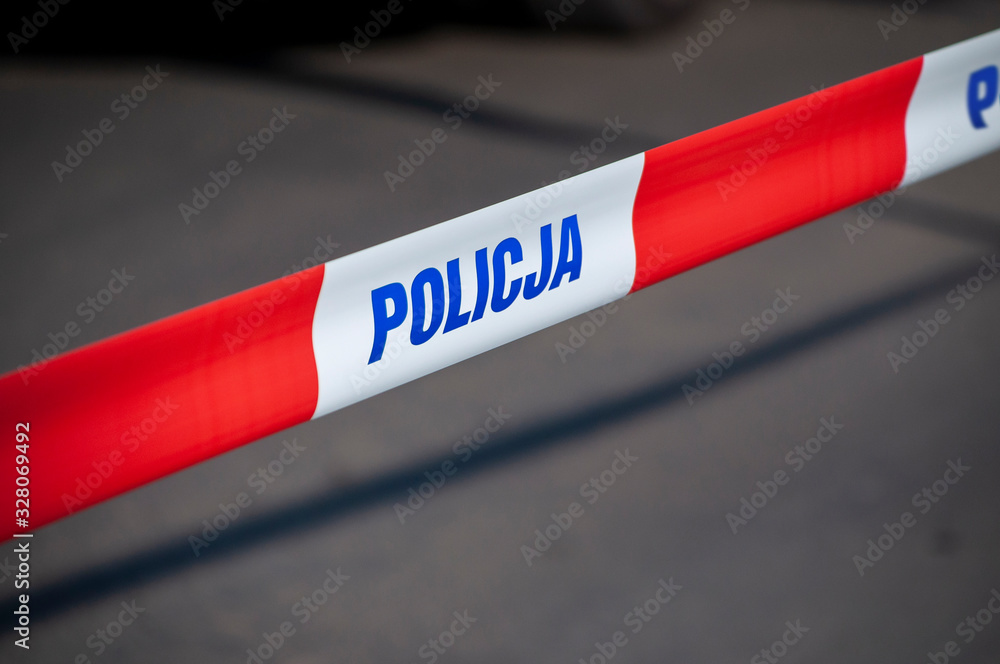 Red and white protection tape with "POLICJA" inscription. Polish police "do not cross" tape - obrazy, fototapety, plakaty 