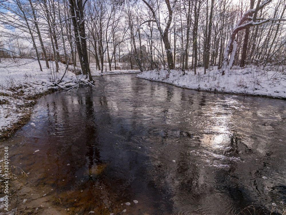 winter landscape with wild fast flowing river, snow covered land winter landscape with wild fast flowing river, snow covered land