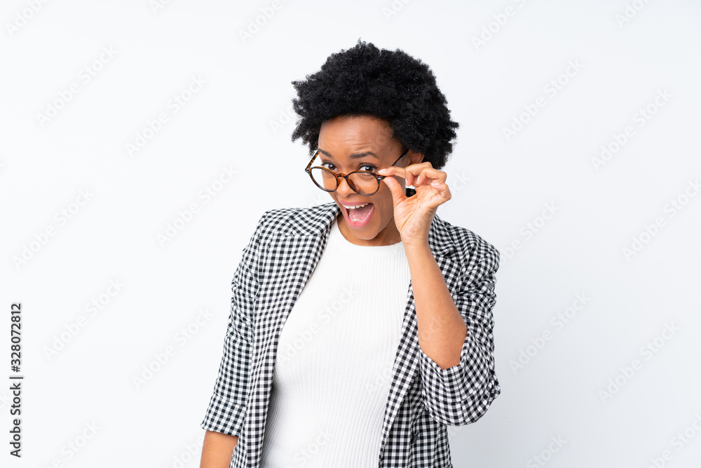 African american woman with blazer over isolated white background with glasses and surprised African american woman with blazer over isolated white background with glasses and surprised