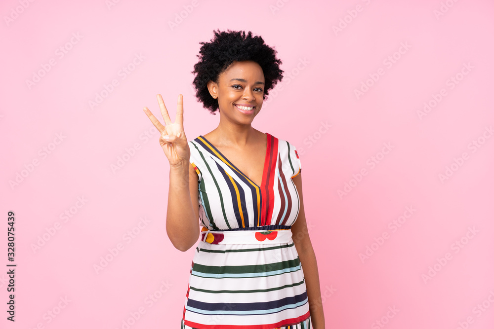 African american woman over isolated pink background happy and counting three with fingers African american woman over isolated pink background happy and counting three with fingers