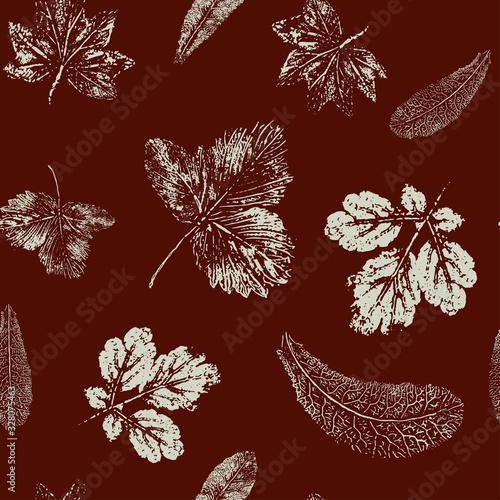 Seamless pattern of white leaf prints on a burgundy background.