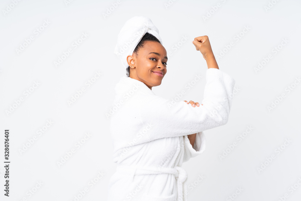 African american woman in a bathrobe over isolated background making strong gesture African american woman in a bathrobe over isolated background making strong gesture