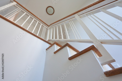 Fotobehang brown wooden stair with white steel balustrade and hardwood handrail banister in