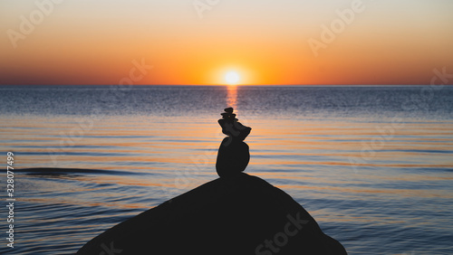Sea with big stones at sunset