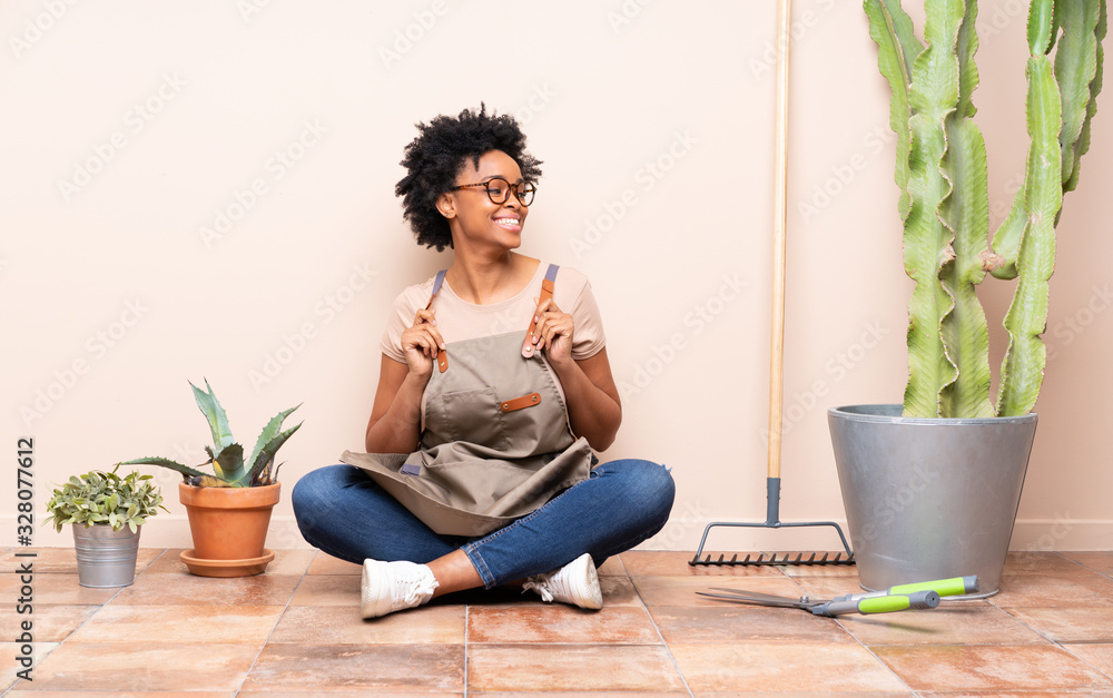 Gardener woman sitting on the floor Gardener woman sitting on the floor
