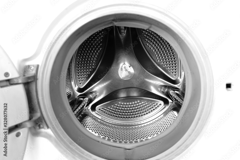 Washing machine drum interior. Perforated stainless steel drum for automatic washing machine. Black and white, metallic background,texture Washing machine drum interior. Perforated stainless steel drum for automatic washing machine. Black and white, metallic background,texture