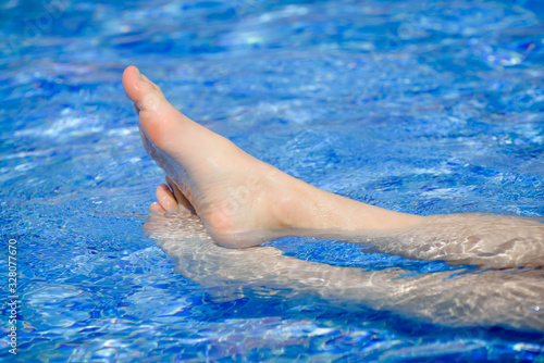 female feet in the outdoor pool
