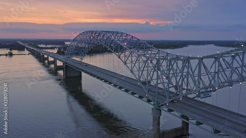 Aerial flying over traffic on the Hernando de Soto Bridge that crosses the Mississippi River at night. The bridge crosses into Arkansas. Memphis, Tennessee, USA photo