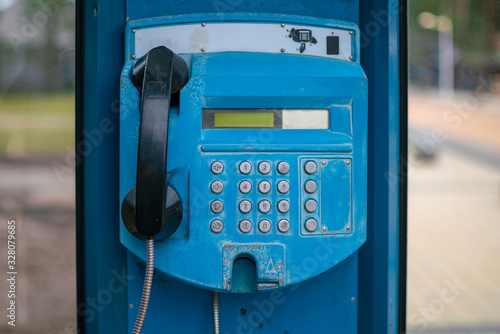 Blue payphone on a city street