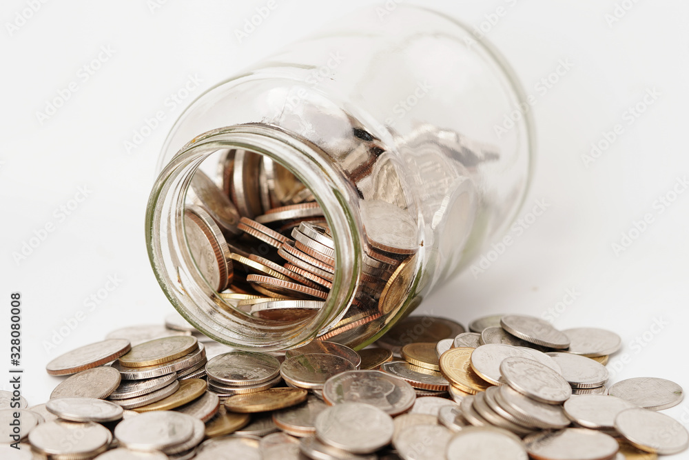 Coins in glass bottle on white background Coins in glass bottle on white background