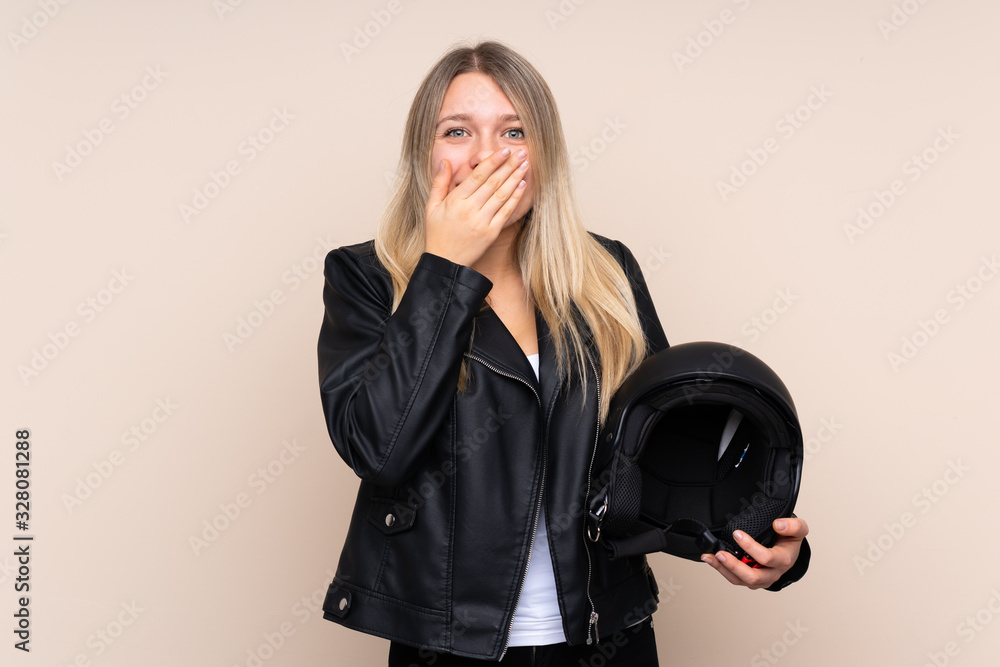 Young blonde woman with a motorcycle helmet over isolated background with surprise facial expression Young blonde woman with a motorcycle helmet over isolated background with surprise facial expression