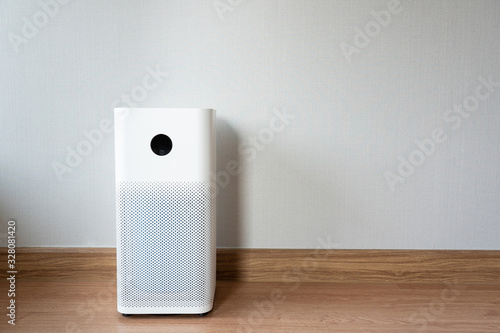 Indoor air purifier with digital monitor screen in bedroom, that show air quality in the room and air pollution levels in the room. PM 2.5 is a major environmental health problem affecting everyone.