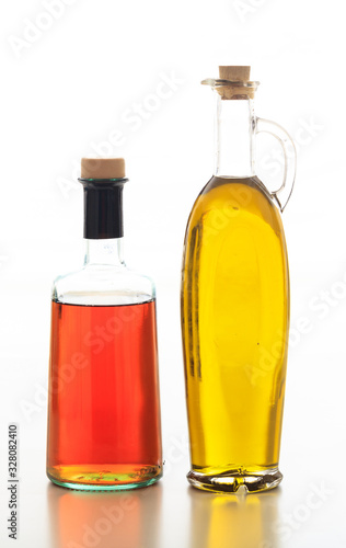 Olive oil and vinegar bottled isolated against white background.