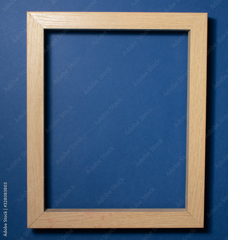 Fototapeta premium Wooden frame on a colored background. Space for copy-paste. Top view of a rectangular frame