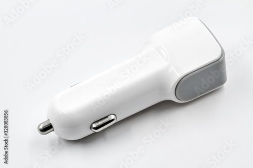 White two port usb car charger on white background. Closeup.