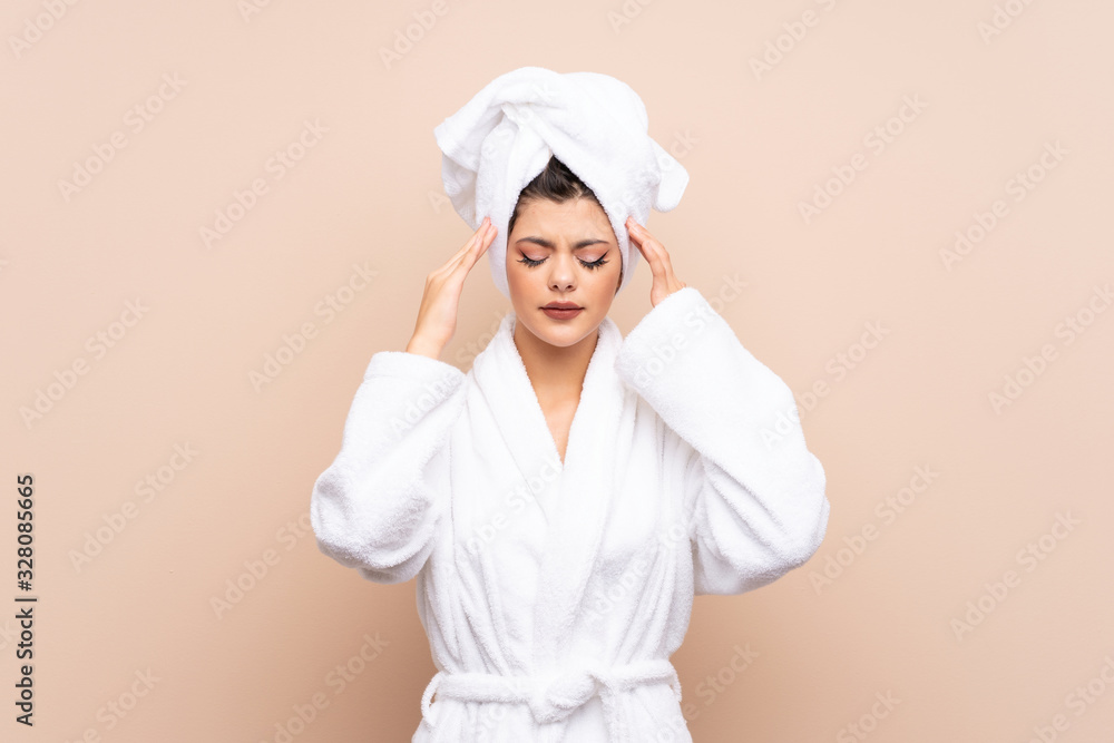 Teenager girl in a bathrobe over isolated background unhappy and frustrated with something. Negative facial expression Teenager girl in a bathrobe over isolated background unhappy and frustrated with something. Negative facial expression