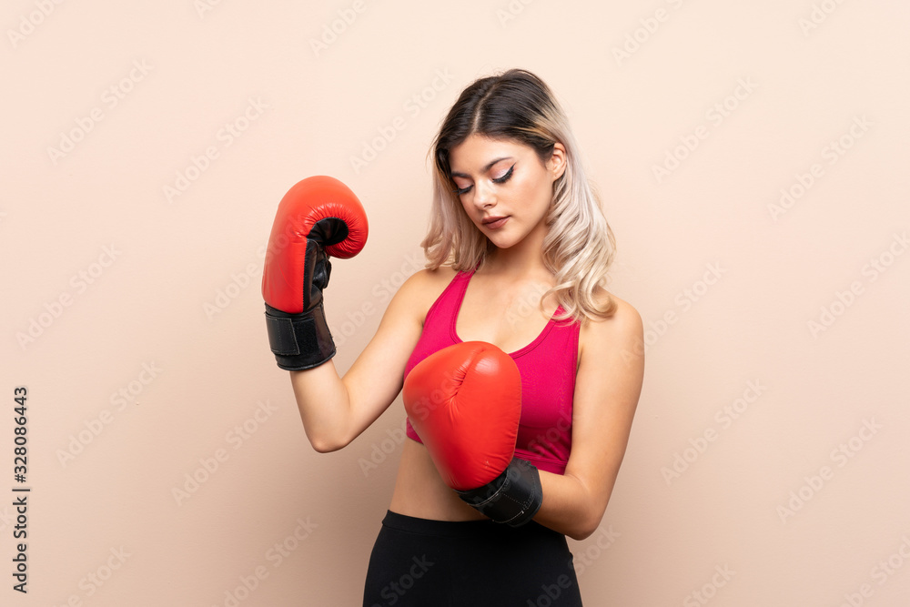 Teenager sport girl over isolated background with boxing gloves