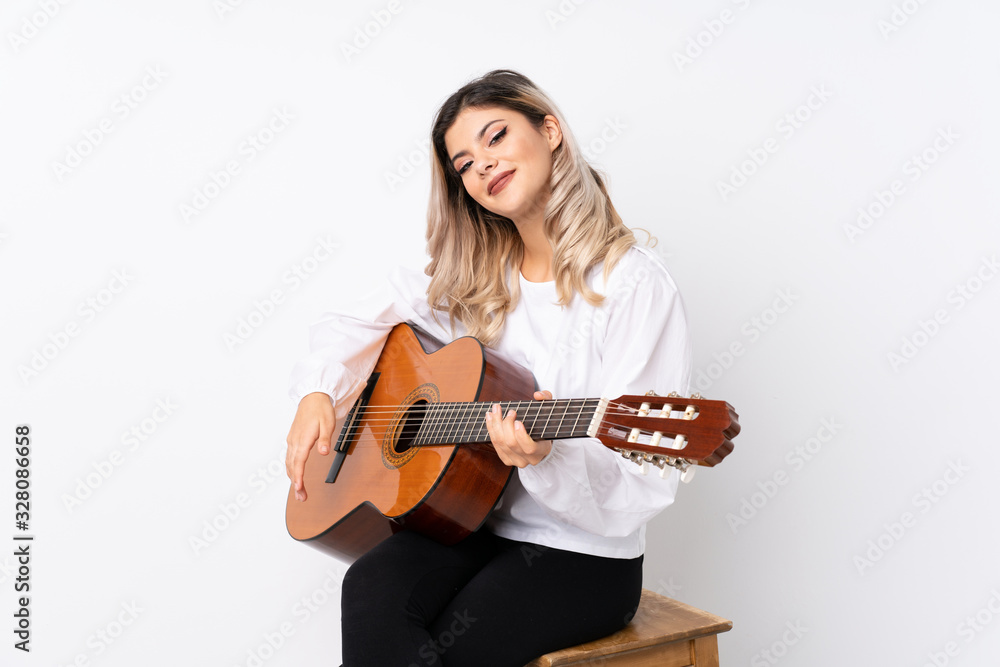 Teenager girl with guitar over isolated white background smiling a lot Teenager girl with guitar over isolated white background smiling a lot