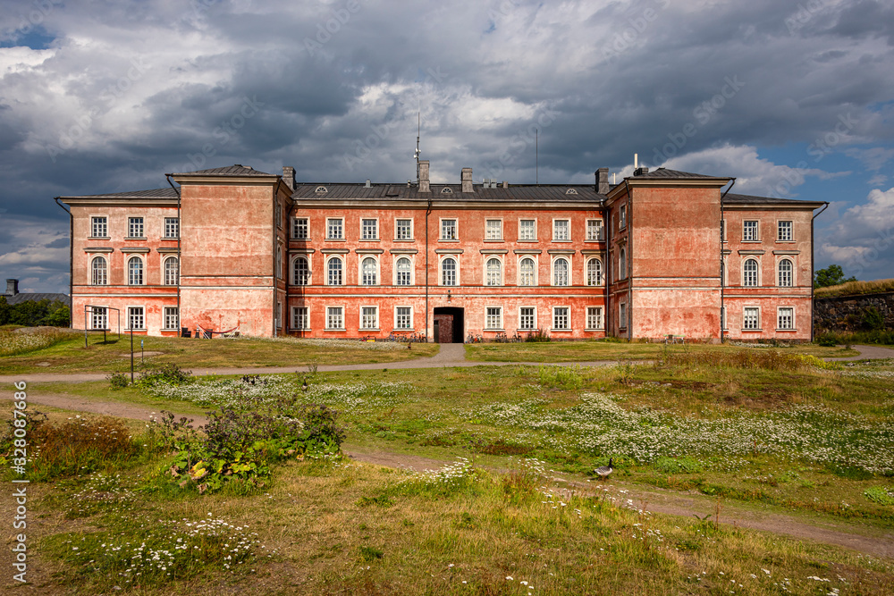 Finland, Sveaborg, Suomenlinna: Panorama view with big building as part of the former prison in the center of the famous Finnish island in the background - concept religion Christianity history travel Finland, Sveaborg, Suomenlinna: Panorama view with big building as part of the former prison in the center of the famous Finnish island in the background - concept religion Christianity history travel