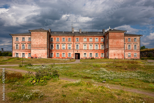 Finland, Sveaborg, Suomenlinna: Panorama view with big building as part of the former prison in the center of the famous Finnish island in the background - concept religion Christianity history travel