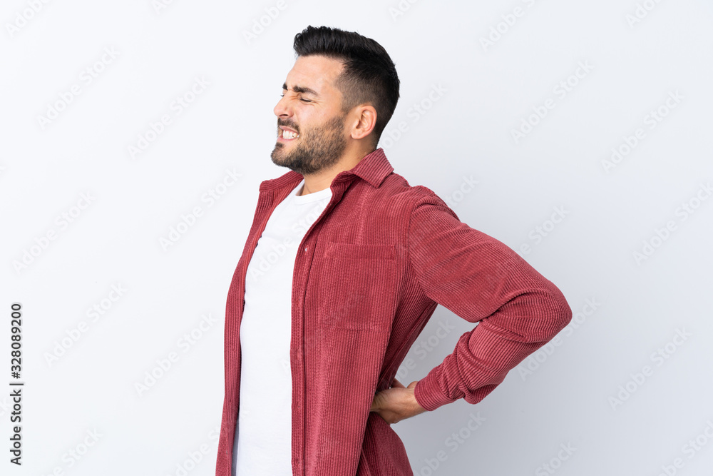 Young handsome man with beard wearing a corduroy jacket over isolated white background suffering from backache for having made an effort Young handsome man with beard wearing a corduroy jacket over isolated white background suffering from backache for having made an effort