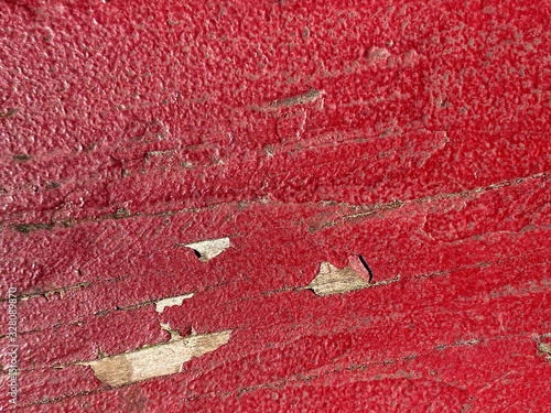 old painted red wood with chipping.