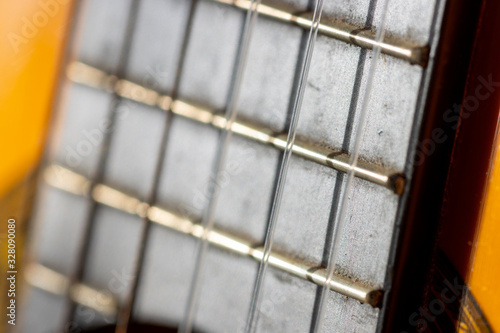 Selective focus on fretboard of acoustic guitar